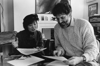 Jin Hi Kim and Charles Amirkhanian seated at a table reviewing papers during the 1990 Composer-to-Composer Festival, Telluride, CO