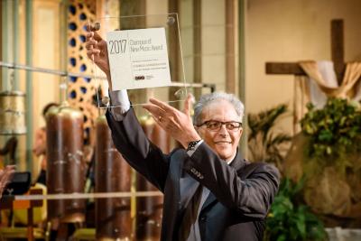 Charles Amirkhanian holding up the Champion of New Music Award given by the American Composers Forum during OM 22, San Francisco CA (May 20, 2017)
