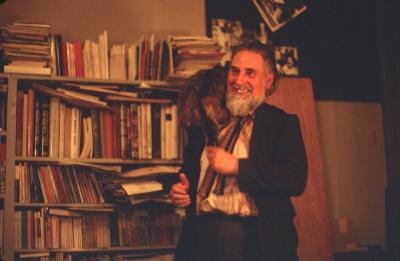 Bob Cobbing, standing, smiling, with cat, London (1972)