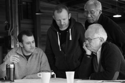 Gyan Riley, Paweł Mykietyn, Tom Johnson, & Kidd Jordan (l to r), half length portrait, seated and standing, looking down at score, Woodside CA., (2010)