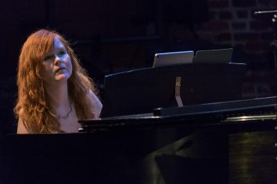Sarah Cahill playing and looking over a piano during OM 23, San Francisco CA (April 11, 2018)