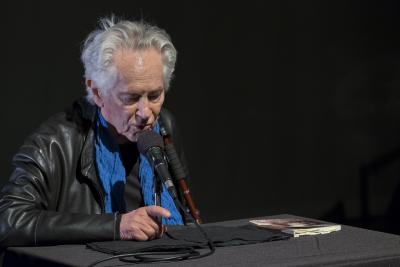 Michael McClure, looking down, during his reading at OM 23, San Francisco CA (April 9, 2018)