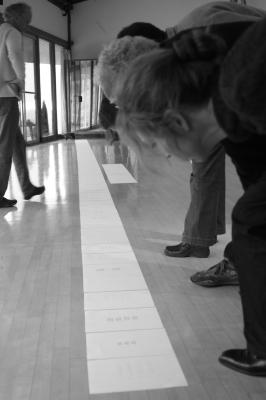 OM 15 composers, bending over, graphic score lined up on the floor, Woodside CA., (2010)