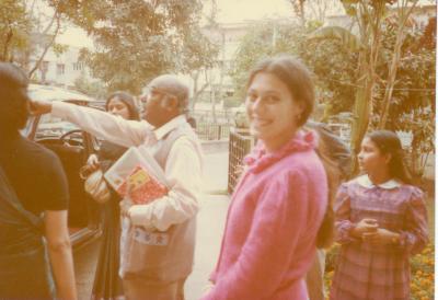 Amelia Cuni, facing camera, smiling, behind Ali Akbar Khan, Delhi, India (ca. 1980s)