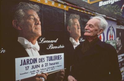 Ivan Wyschnegradsky posing next to a billboard image of Leonard Bernstein, Paris (1976)