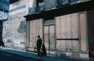 A portrait of Charles Amirkhanian walking down an old street in Paris, France, 1976