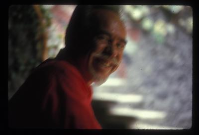 A blurry head and shoulders portrait of Conlon Nancarrow smiling, 1969