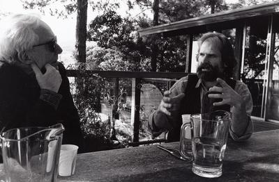 Robert Ashley & Trimpin, heads and shoulders portrait, seated at table, facing each other, Woodside CA, (1993)