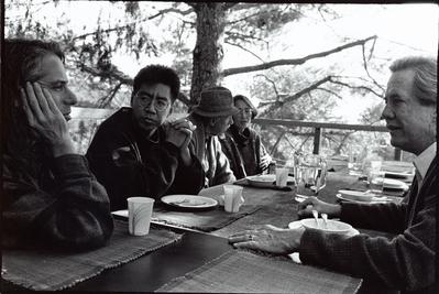 Several artists from the 1st Other Minds Festival seated at the outdoor dining table at the Djerassi Resident Artists Program, Woodside, CA (1993)