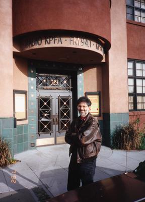 Charles Amirkhanian, standing in front of the KPFA building, facing forward, 1992